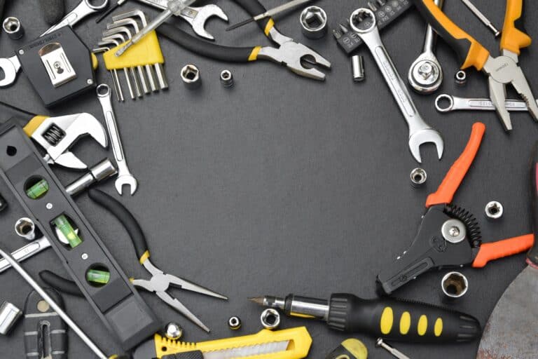 Handyman tool kit on black wooden table with copy space