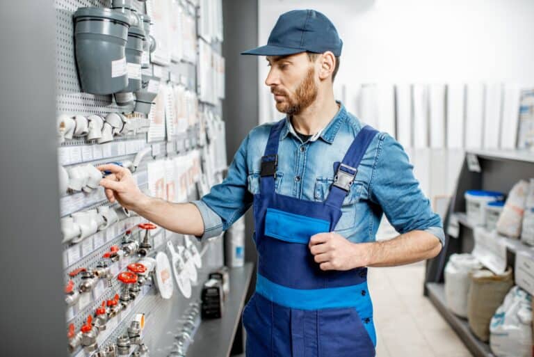 Man choosing water pipes in the shop